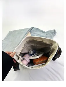 Internal view of spacious white tote bag showing storage for umbrella and tablet