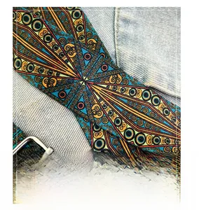 Close-up of ethnic geometric print woven shoulder strap with silver metal buckle