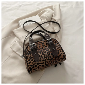 Detail of vintage leopard print mini bag with dark brown straps and silver metal rivets