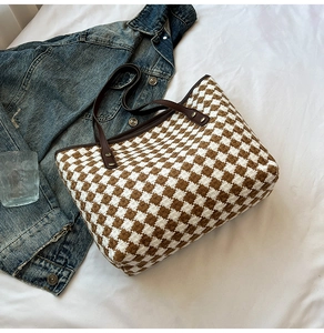 Close-up of woven tote bag texture featuring brown and white checkered tweed fabric
