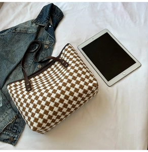 Top-down view of woven tote bag with brown checkered pattern and durable leather handles
