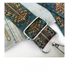 Close-up of decorative bohemian shoulder strap with metal buckle and mandala patterns