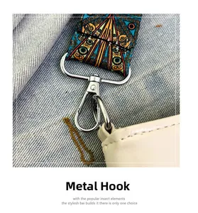 Detailed close-up of a silver metal hook on a colorful retro patterned wide shoulder strap