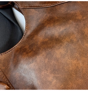 Macro shot of brown leather texture and neat stitching details on a stylish tote bag