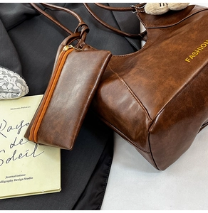 Detailed macro view of vintage brown leather tote bag texture with fashion lettering