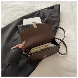 Internal view of the dark brown leather shoulder bag showing storage for phone and wallet