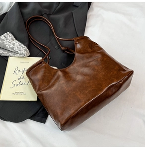 Macro detail of deep brown vintage leather tote bag with natural grain texture
