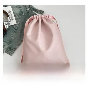 Detail of soft pink drawstring nylon backpack with matching straps for urban lifestyle