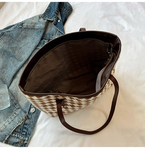 Interior view of houndstooth tote bag featuring deep brown lining and zipper pocket