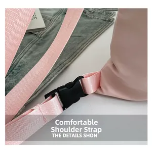 Detail shot of the comfortable pink nylon shoulder strap and black buckle on the backpack