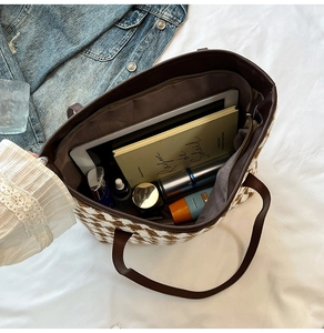 Spacious tote bag interior showing large capacity for books and cosmetics in macro view