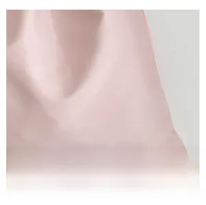 Detailed macro view of high-quality light pink nylon fabric with subtle silk sheen texture