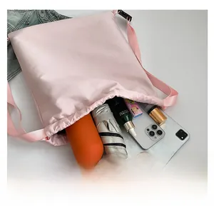 Detailed internal view showing large storage capacity for water bottle, umbrella and phone