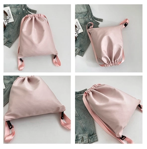 Detail view of pink nylon backpack featuring drawstring closure and pearlescent finish