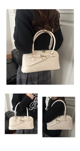 Multiple views of a cream faux leather shoulder bag showing crossbody and handheld styles
