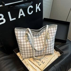 Large woven tote bag with brown houndstooth pattern and elegant leather shoulder straps