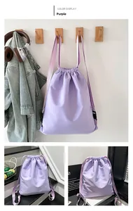 Detail of light purple drawstring backpack with wide straps and water-resistant fabric