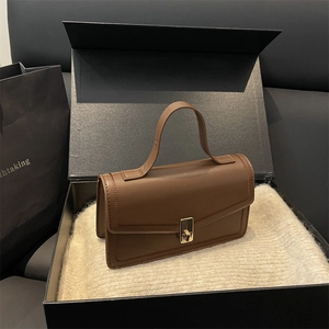 Elegant retro brown leather handbag with gold twist lock and stitching in a gift box