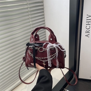 Burgundy patent leather shoulder bag with lace bow and metal chain gothic design