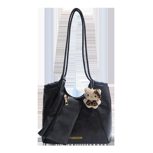 Black leather tote bag set with golden logo, small pouch, and leopard plush charm