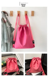 Detail view of rose red drawstring backpack with adjustable straps and buckle closure