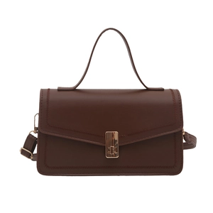Deep brown minimalist faux leather handbag with gold buckle and adjustable strap
