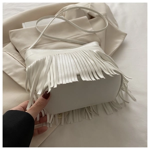 Detail shot of white leather tassel bag showing wide bottom and soft PU texture