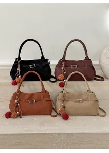 Four retro matte leather tote bags in black, burgundy, caramel, and beige on stone steps