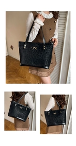 Detail view of large black leopard print tote bag with golden bow hardware ornament