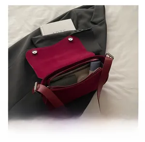 Macro shot of dark red matte bag interior showing zipper compartment and daily storage space