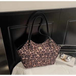 Detail of leopard print tote bag with gold metal twist lock and studded accents