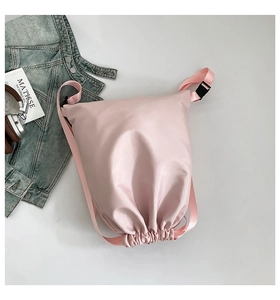 Pink drawstring backpack detail with adjustable buckle and water-resistant nylon material