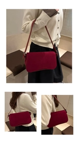 Detail showing high-quality burgundy suede crossbody bag worn on model's shoulder