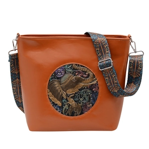 Vintage brown leather tote bag with elephant embossment and colorful woven strap