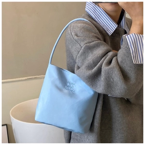 Détail du sac bleu clair avec texte Hope and future embossé et texture en cuir mat de luxe