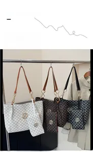 Detail view of the tote bag set featuring M-pattern print and gold chain strap handles