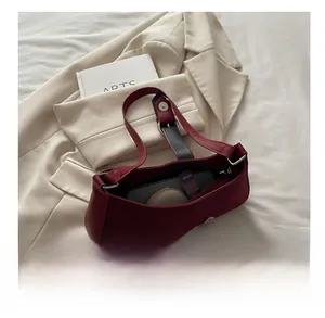 Detail of the interior capacity of this deep red leather crescent shoulder bag