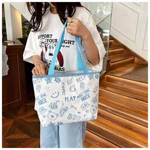 Close-up of white canvas tote with blue doodle prints and stylish star patterns