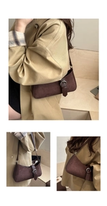 Close-up of retro brown suede crescent bag featuring a leather buckle and fine texture