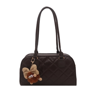 Deep chocolate quilted tote bag with long handles and a cute plush monster pendant