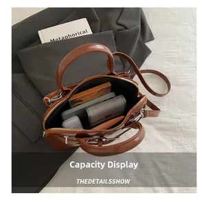 Interior view of brown glossy leather handbag showing storage space for daily items