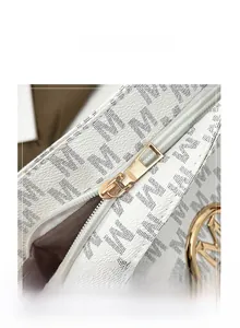 Detail of white lychee leather tote with monogram print and golden metal zipper hardware