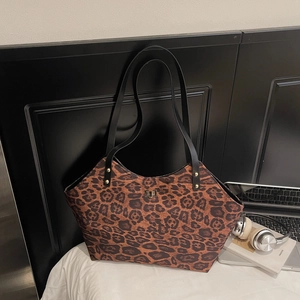 Leopard print large tote bag with black straps and gold lock for urban fashion commute