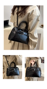 Detail of black glossy handbag with belt buckle hardware and detachable shoulder strap
