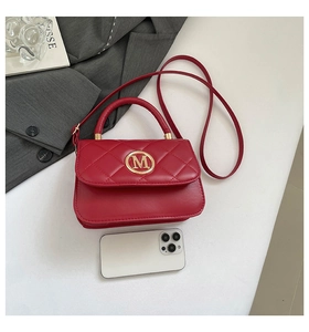 Top view of red quilted leather handbag with gold M buckle and rhombus stitching