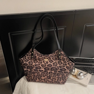 Stylish large leopard print tote bag with black handles and gold lock for office commute