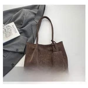 Detail view of dark brown suede tote bag set with decorative center stitching and pouch