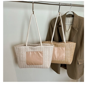 Detail of woven tote bags with herringbone texture and soft leather logo patches