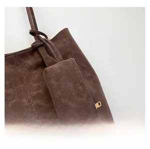 Detailed macro view of dark brown frosted suede leather texture and golden zipper hardware