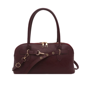 Minimalist burgundy shell bag with leather strap buckle and golden hardware details